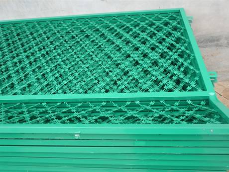 Several pieces of green color PVC coating welded razor wire mesh on the ground.